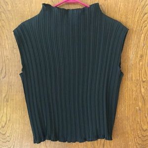 Black top with modified turtle neck effect. Mini pleats